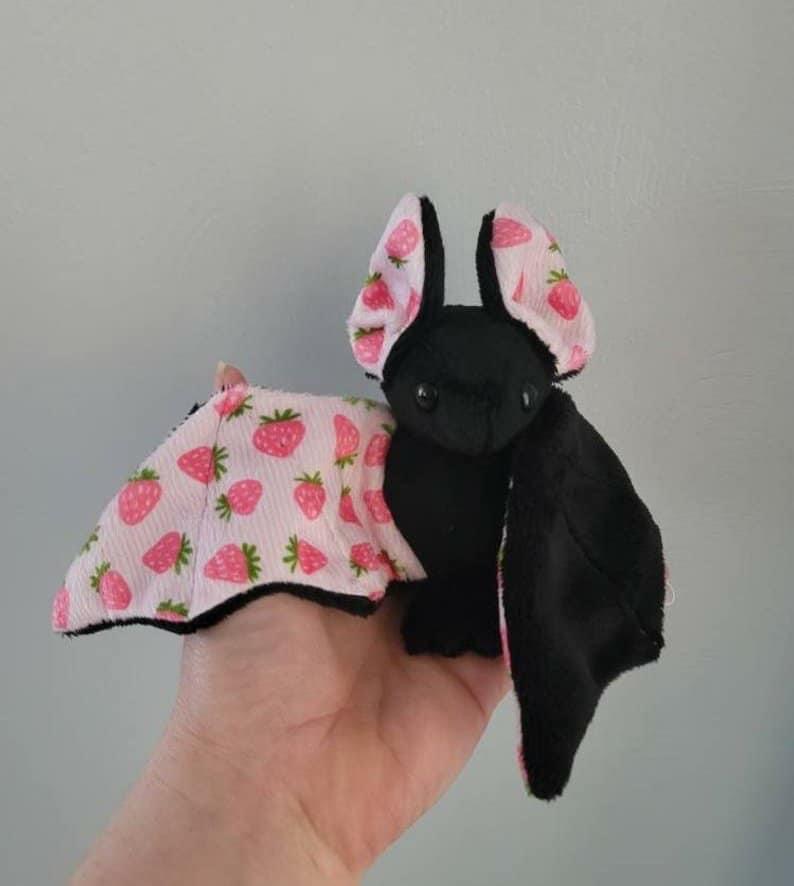 A strawberry/goth bat plushie