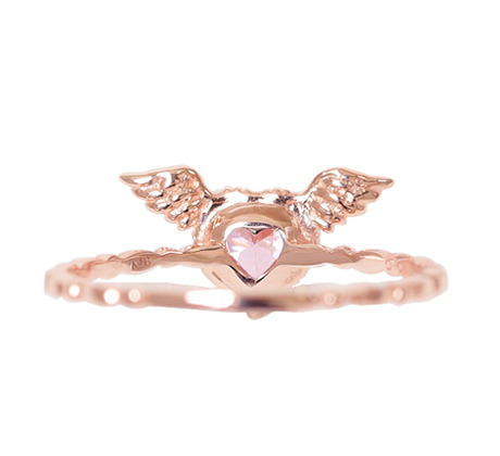 A ring with angel wings and a pink heart in the middle