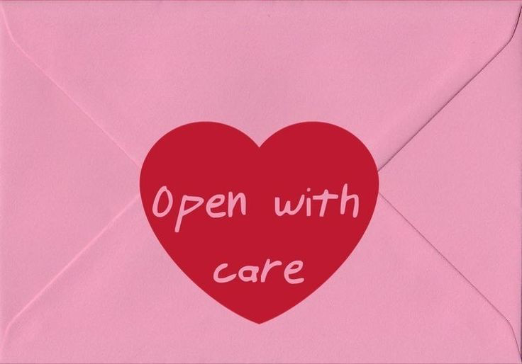 A letter with a heart that reads "open with care"